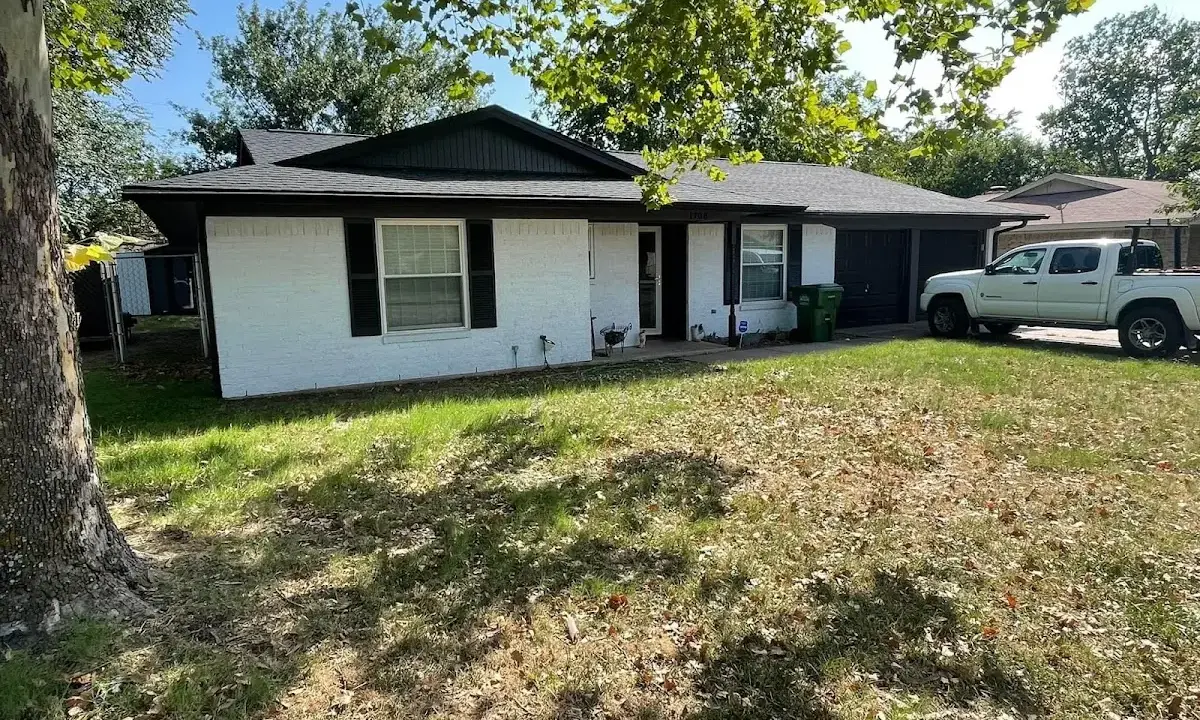 Professional roofing crew working on a residential roof in Clifton Heights